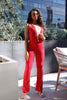 • Red matching set with sleeveless crop top and flare pants in bold statement color
