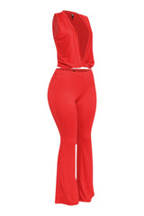 Bold red two-piece set with deep plunge twist top and high-waisted flare pants perfect for going out or elevated lounge looks