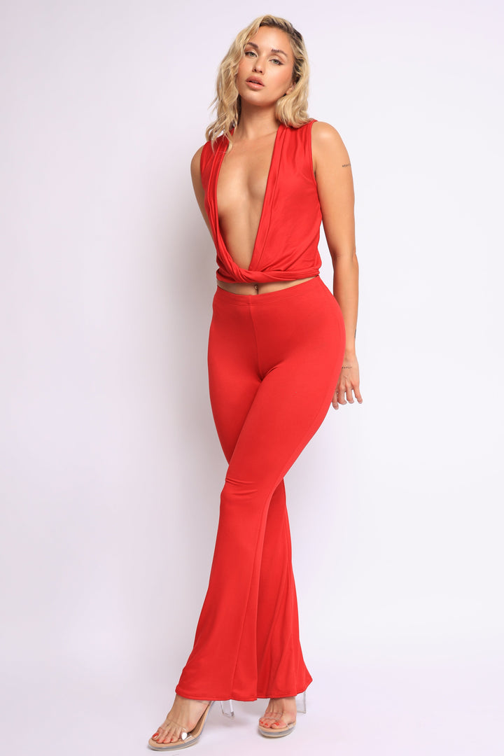 Bold red deep V neckline two-piece set with twisted crop top and flared pants


