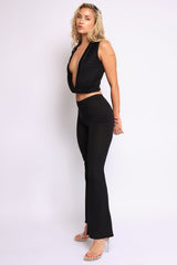 Sexy black two-piece twist front top and flare pants set with deep V neckline

