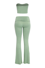 Soft sage green tube top and flared pant outfit with crossover waist detail

