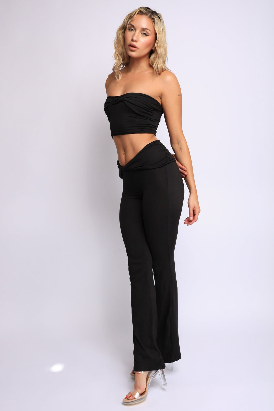 Black twist bandeau top and flared pants two-piece set with sleek finish

