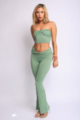 Light green lounge set featuring twist front bandeau top and stretchy flare bottoms

