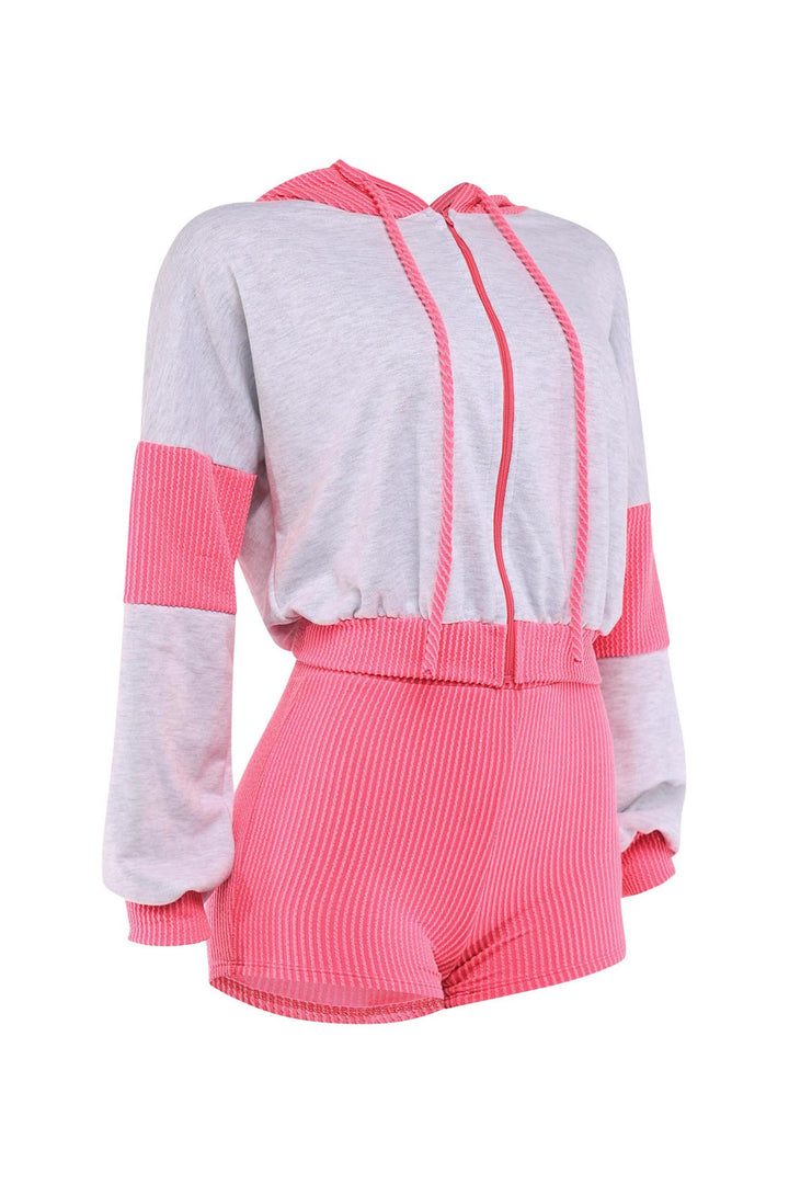 Hot pink shorts with ribbed texture paired with a grey hoodie with pink accents

