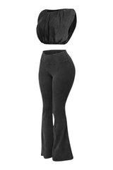 Left angle showing black cotton two-piece with voluminous top and flared hem