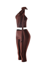 Right angle showing full brown satin outfit with long tie shoulder bow and fitted waist