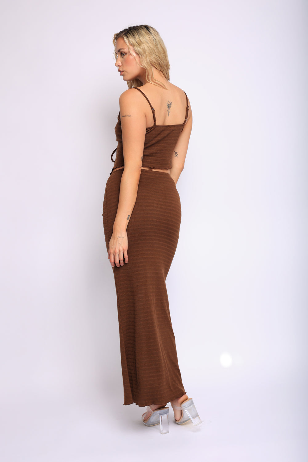 Chocolate brown two-piece outfit with ruched bustier and long curve-hugging skirt

