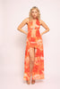 Flowy halter top with sleeveless cut in orange swirl print and stretch mini skirt

