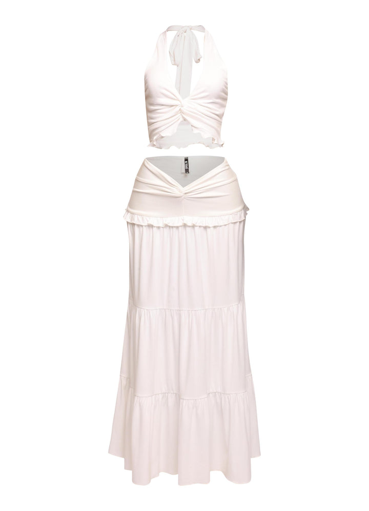 White beach-ready outfit with halter tie-back and merrow hem details

