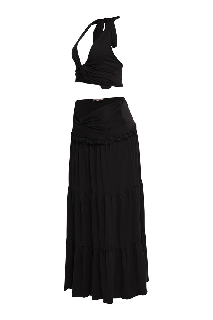 All-black summer outfit with tiered silhouette and sultry halter top


