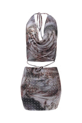 Two-piece outfit with a patterned top and skirt on a white background