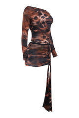 Brown and black patterned dress with long sleeves and a tie detail on a white background