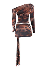 One-shoulder dress with a long tie and patterned design on a white background