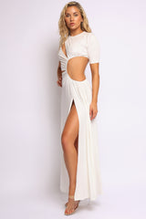 Elegant white slit dress with twist detail and elevated resort style

