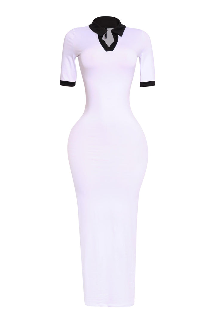 Sporty white and black contrast dress with tight stretch fabric, shown from the left side

