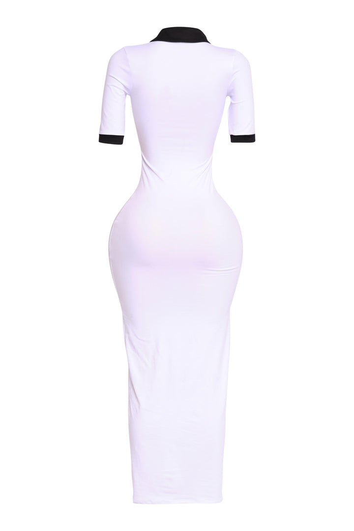 Back angle of white polo-inspired maxi with black collar and cuffs, minimalist athletic vibe

