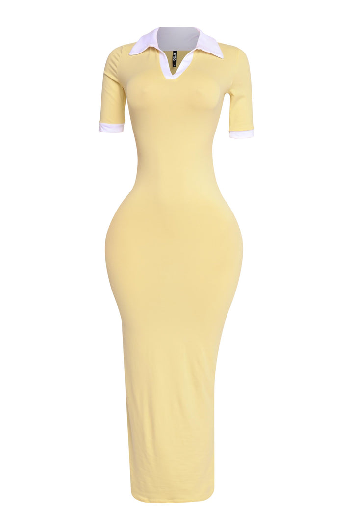 Yellow and white polo-style dress with short sleeves, side profile showing athletic chic silhouette

