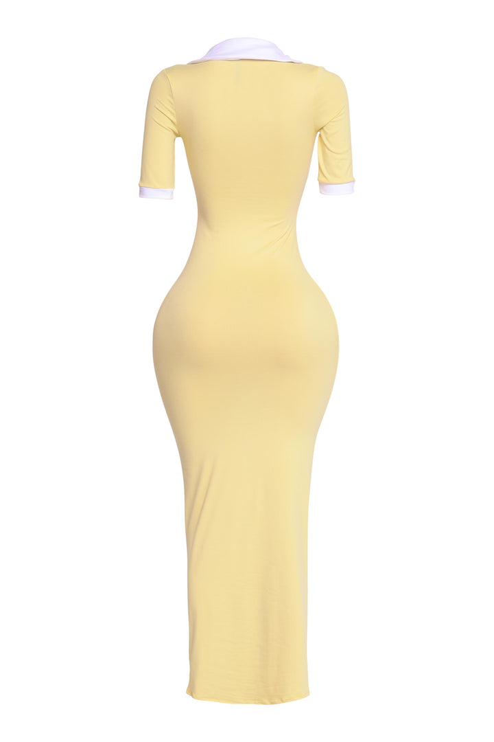 Back view of yellow and white bodycon maxi dress with white contrast details and sleek stretch fit

