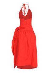 Red vacation-ready midi with wrap skirt, halter straps, and bold feminine energy