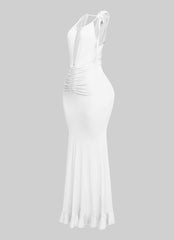 White beachy halter dress with deep neckline and flirty movement

