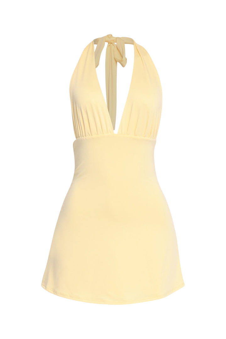 Breezy yellow halter dress with low back and feminine silhouette

