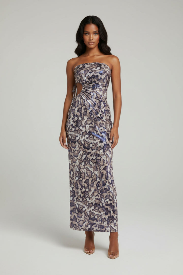 Woman wearing a strapless floral dress on a plain background