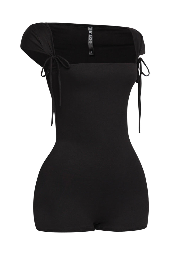 Fitted black one-piece romper featuring side view of tight silhouette and tied cap sleeves

