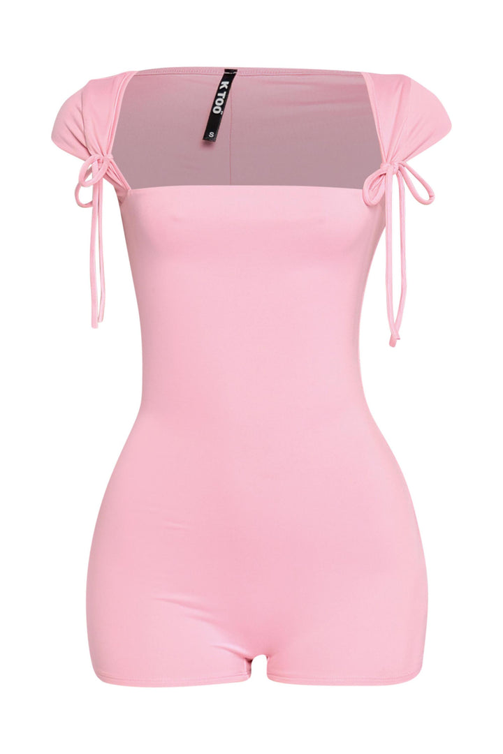 Baby pink cap sleeve romper with front-tie shoulder accents and soft girlcore energy

