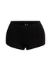High-waisted black micro mini shorts with pintuck detailing and an elastic waistband, offering a sleek and stylish fit for bold, everyday outfits.