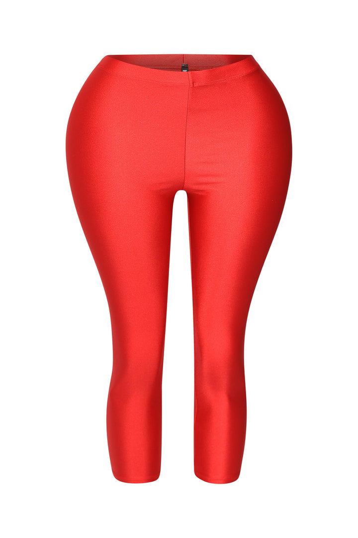 Bold red shiny capri leggings with high-rise waist and sleek finish

