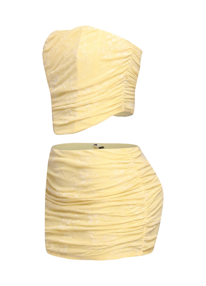 Back zipper detail on yellow bandeau top with ruched mini skirt

