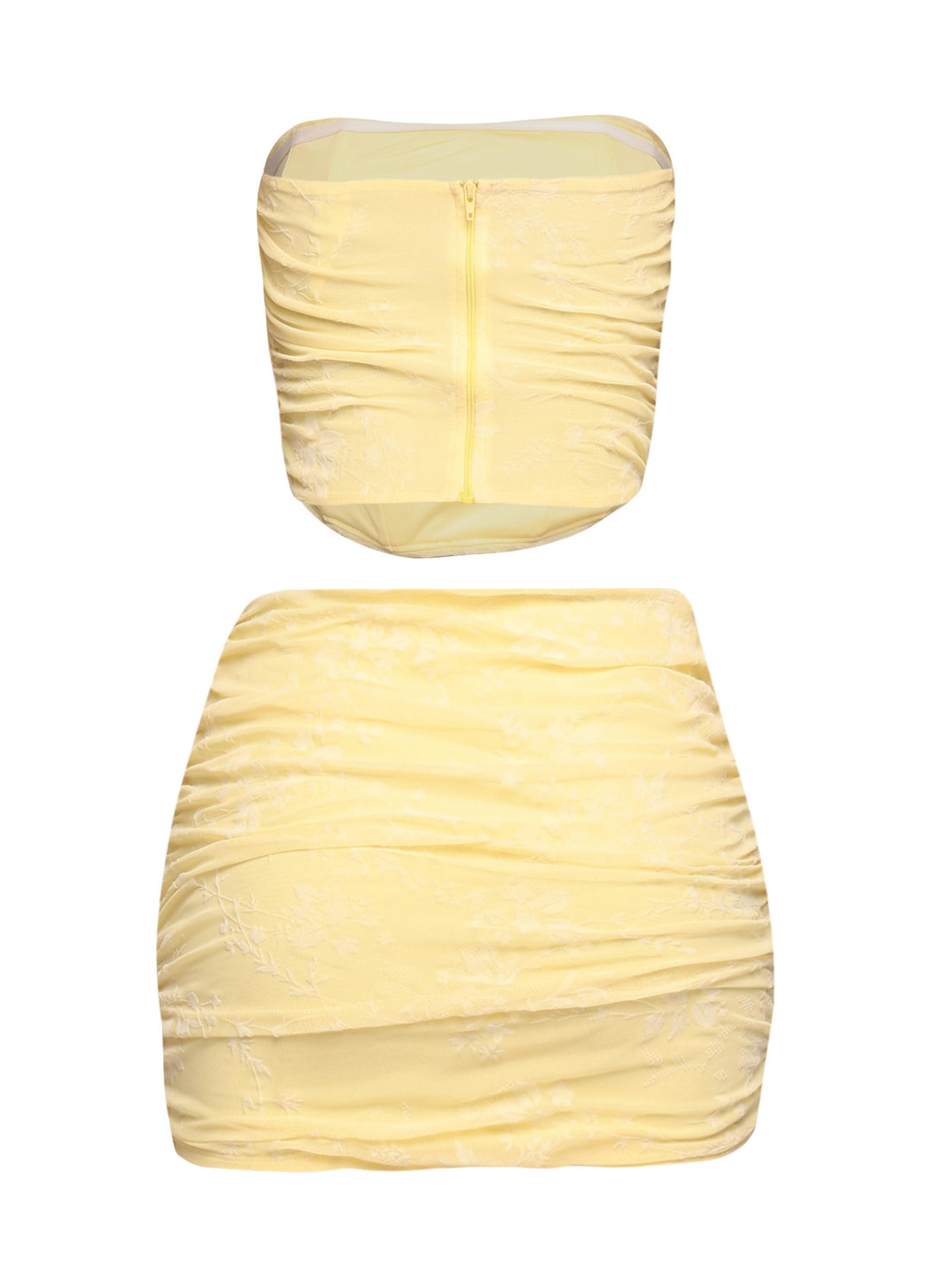 Side view of yellow ruched jacquard tube top and curve-hugging mini skirt

