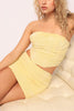 Angled closeup of yellow floral textured set with gathered seams

