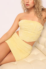 Angled closeup of yellow floral textured set with gathered seams

