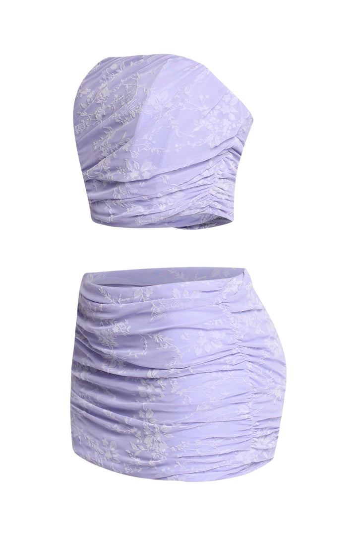 Back view of lavender crop top with exposed zipper and matching skirt

