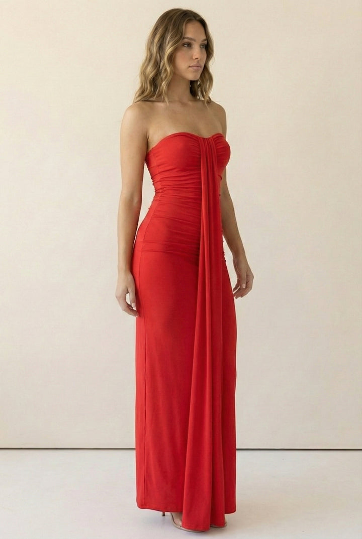 Body-contouring red maxi dress with side ruching and pull-on strapless neckline; form-fitting silhouette trending in night-out outfits